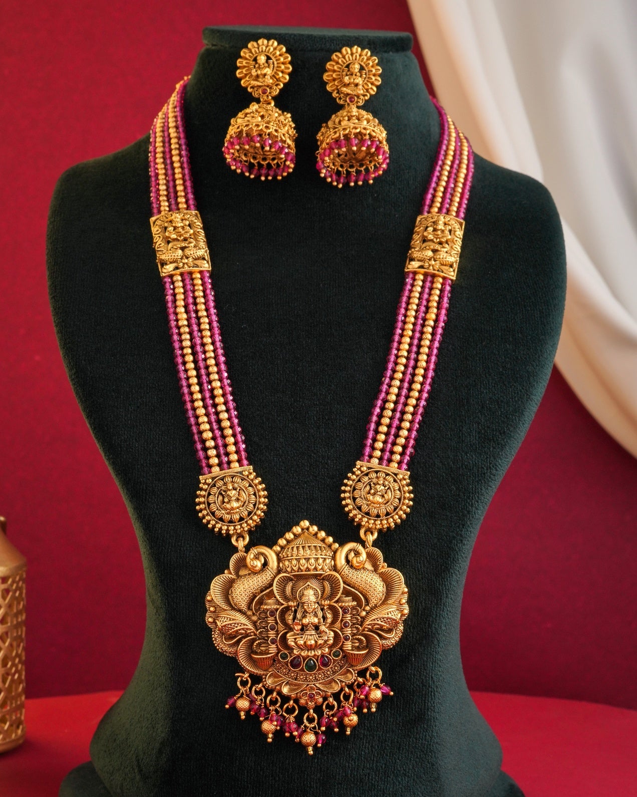 Traditional Antique Gold-Plated Lakshmi Pendant Haram - Ruby Pink Multi-Strand Bead Long Necklace with Matching Jhumka Earrings