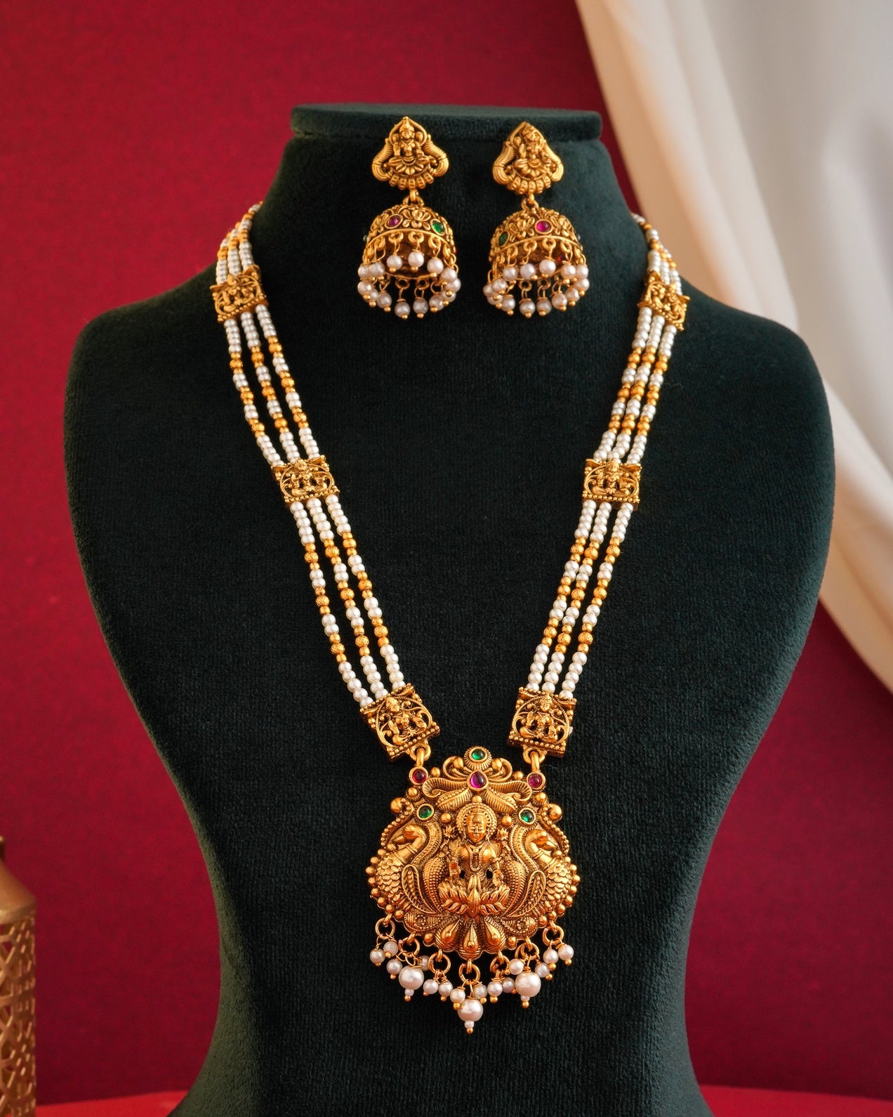Antique Matte Gold Goddess Lakshmi Long Necklace Set - Triple Strand Pearl Haram with Matching Jhumka Earrings & Kemp Stone Accents